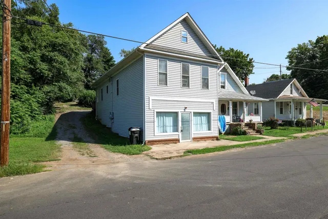 a front view of a house with a yard and table and chairs