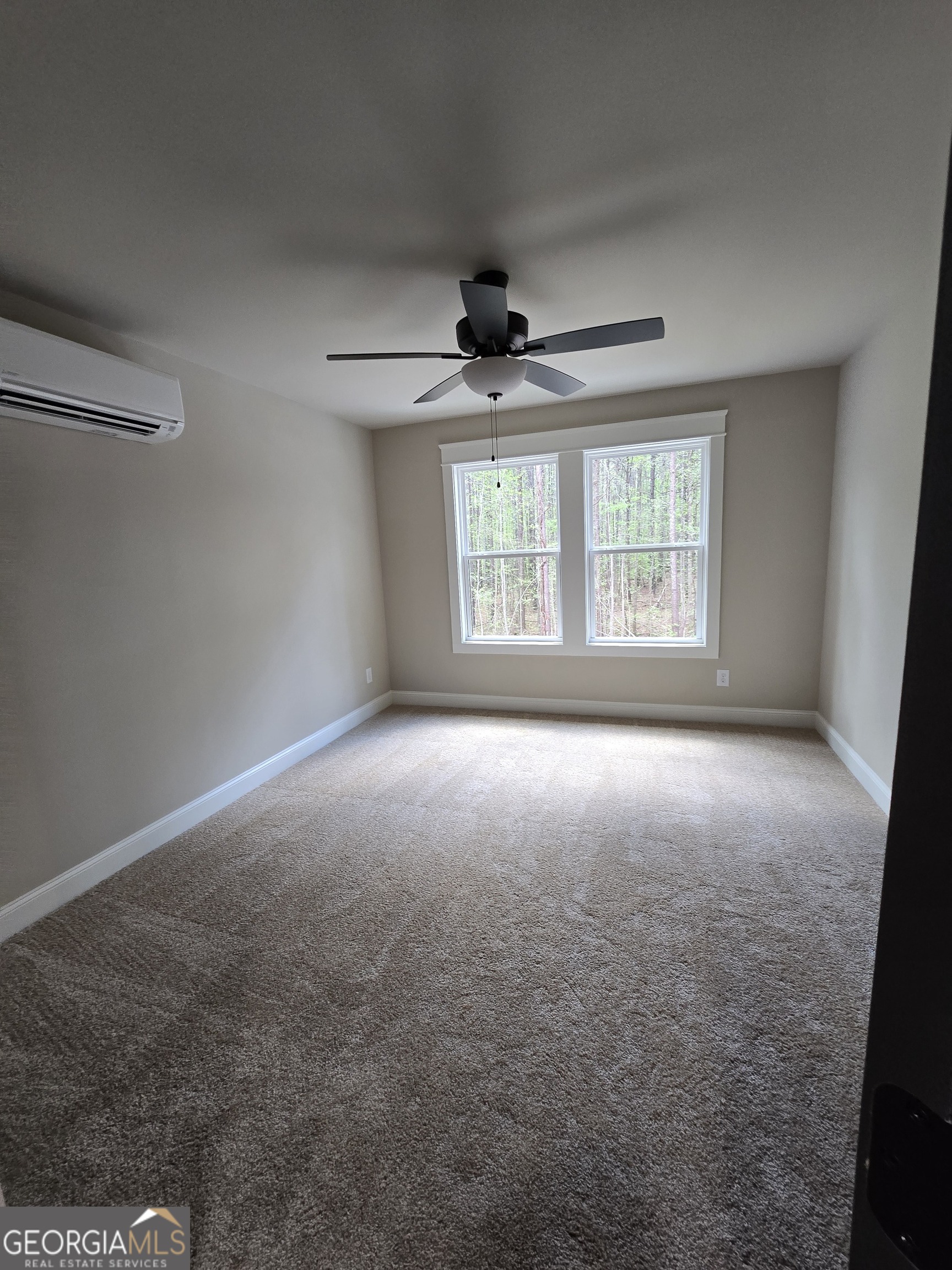1620 Bar J Road Temple, GA 30179 - Photo 22 of 73 an empty room with windows and ceiling fan