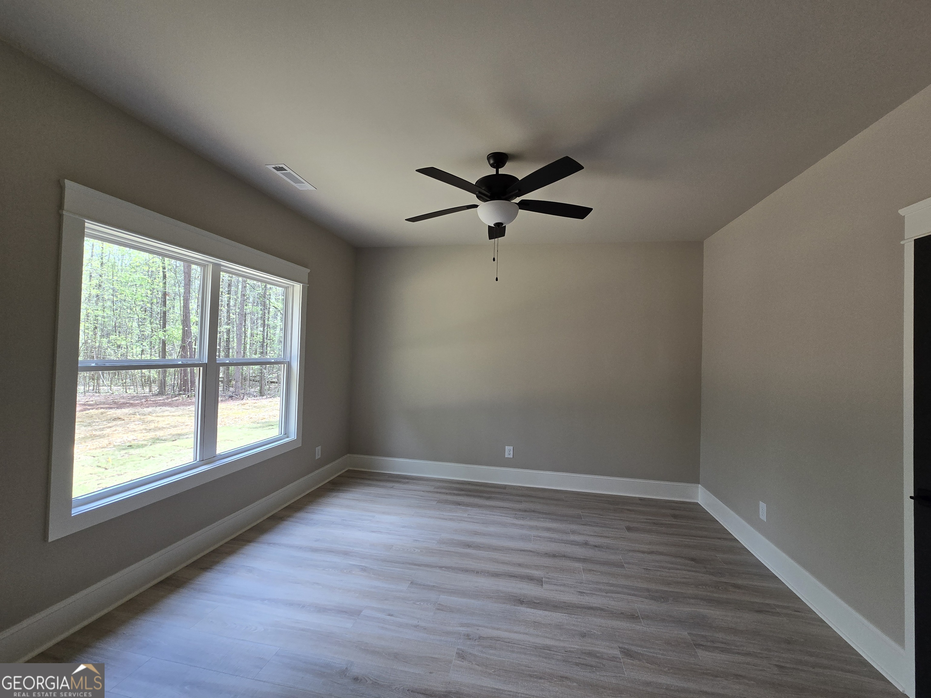 1620 Bar J Road Temple, GA 30179 - Photo 42 of 54 wooden floor in an empty room with a window