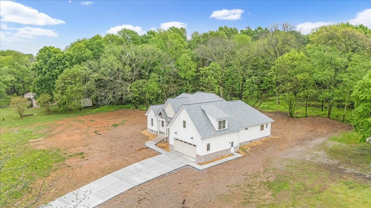 50 Lindsley Road Lebanon, TN 37090 - Photo 3 of 78 an aerial view of a house with yard and trees in the background