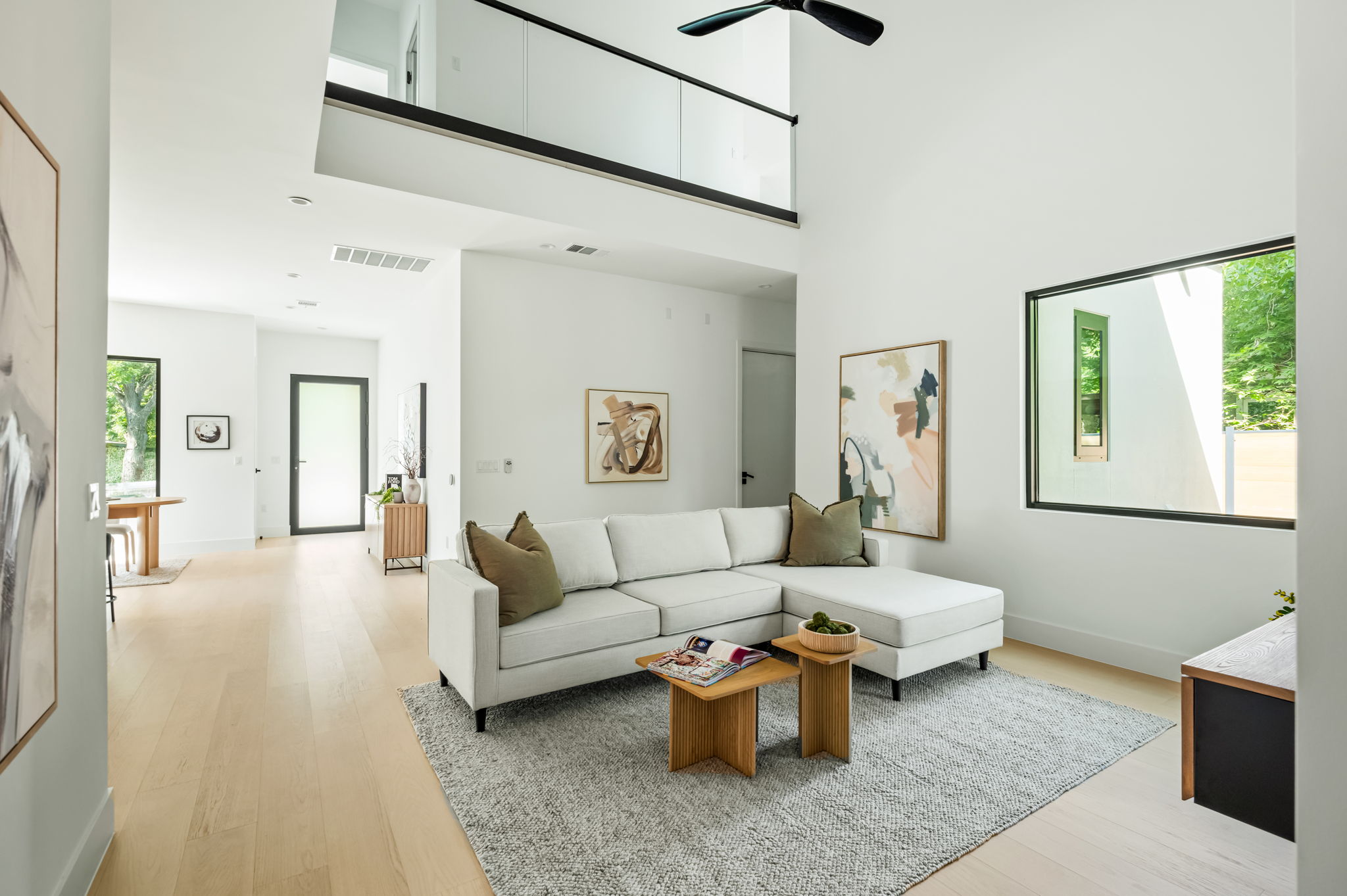 3210 Thompson Street Austin, TX 78702 - Photo 11 of 39 Two-story ceilings and light wood floors define this modern open-concept living space.