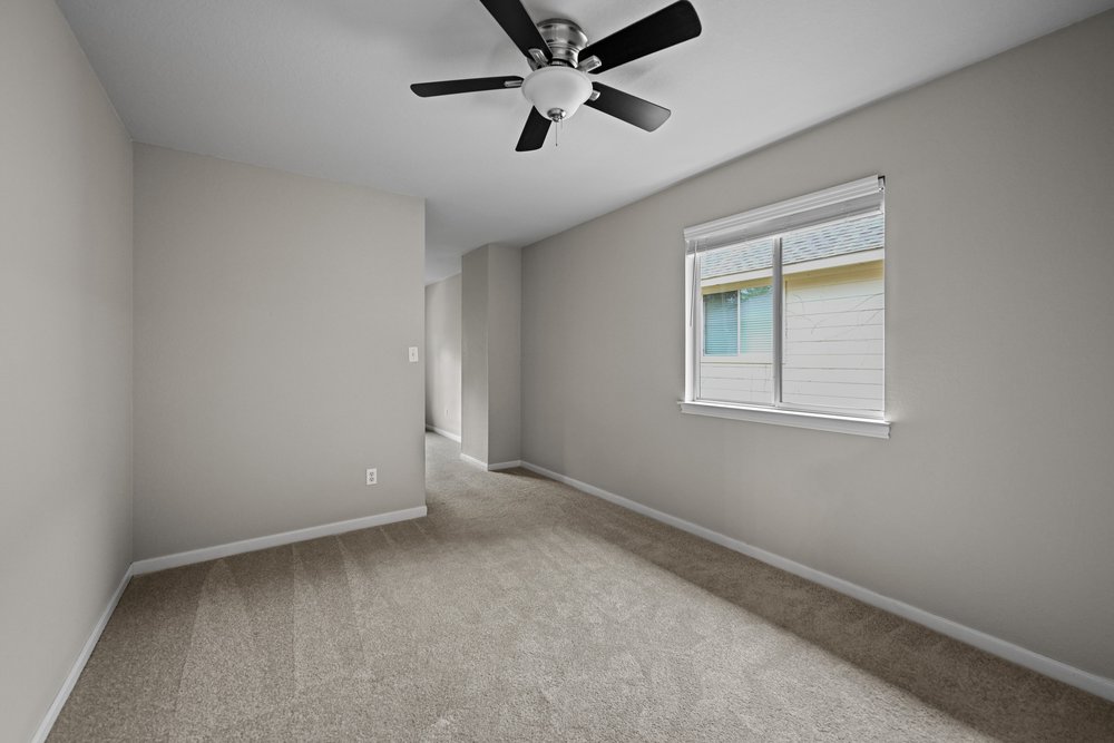 2823 Lantana Ridge Drive Austin, TX 78732 - Photo 22 of 34 an empty room with a window and a fan
