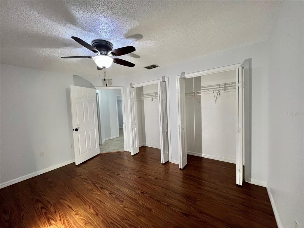 7469 Pond Circle Spring Hill, FL 34606 - Photo 13 of 22 a view of an empty room with wooden floor