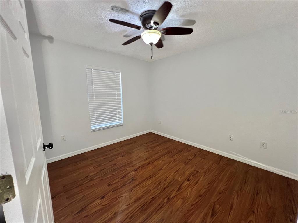 7469 Pond Circle Spring Hill, FL 34606 - Photo 14 of 22 wooden floor in an empty room