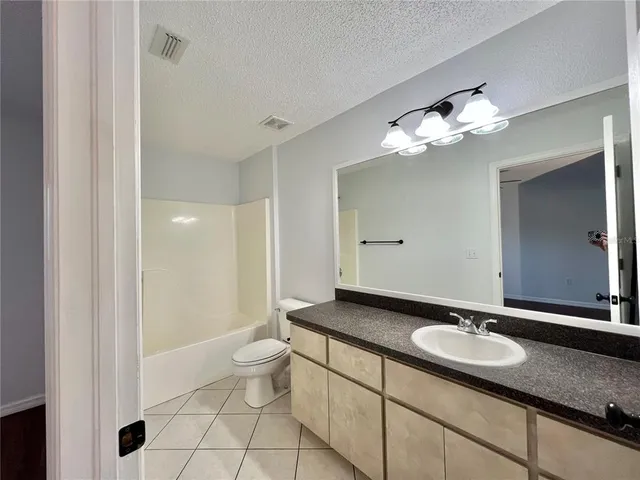 a bathroom with a sink toilet and mirror