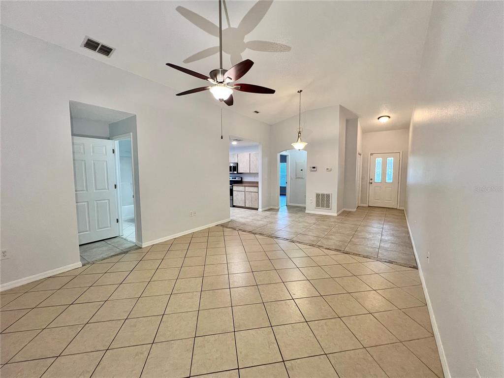 7469 Pond Circle Spring Hill, FL 34606 - Photo 6 of 22 a view of an empty room and a chandelier fan
