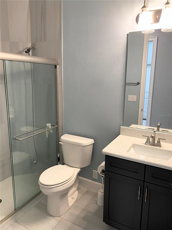 11 Rio Vista Drive Palm Coast, FL 32137 - Photo 20 of 38 a bathroom with a toilet a sink and shower