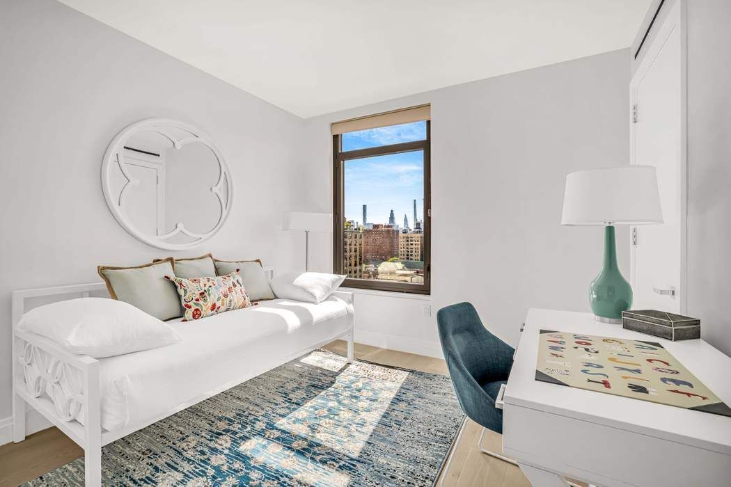 212 West 95th Street, Unit 17B Manhattan, NY 10025 - Photo 10 of 24 a living room with furniture a lamp and a rug