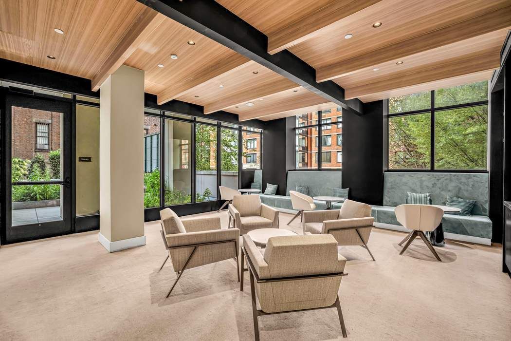 212 West 95th Street, Unit 17B Manhattan, NY 10025 - Photo 14 of 24 a living room with furniture and a large window