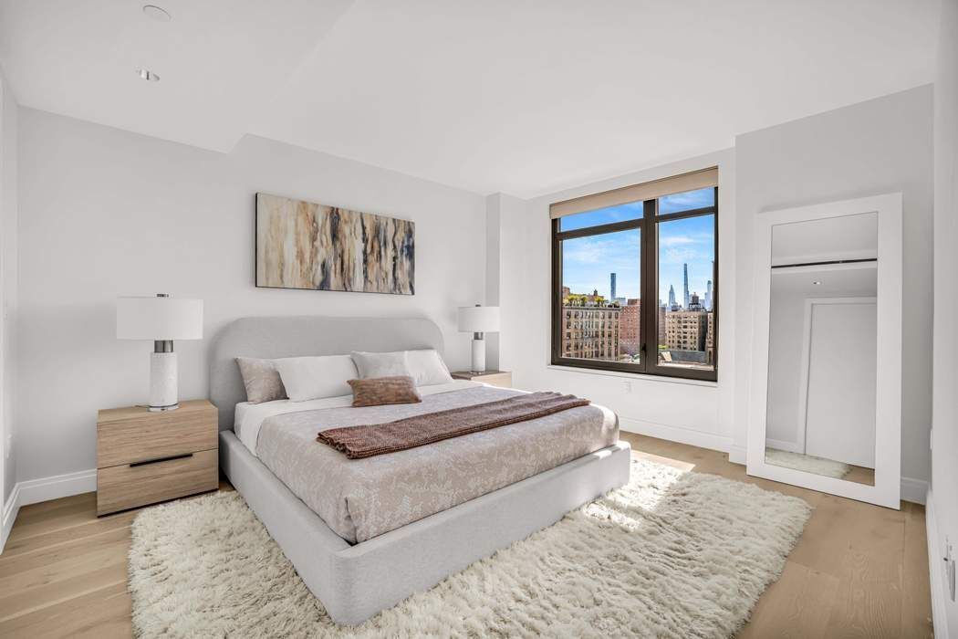 212 West 95th Street, Unit 17B Manhattan, NY 10025 - Photo 5 of 24 a spacious bedroom with a large bed and a couch