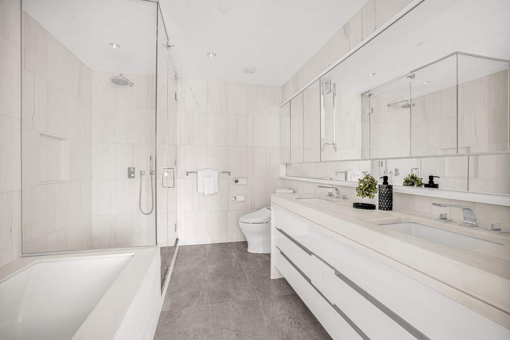 212 West 95th Street, Unit 17B Manhattan, NY 10025 - Photo 6 of 24 a bathroom with a sink a toilet and shower