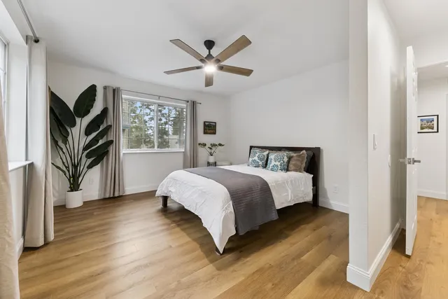 a bedroom with a large bed and a chandelier