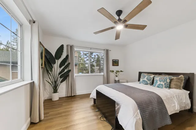 a bedroom with a large bed and a chandelier