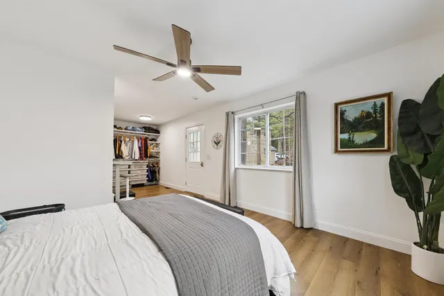a bedroom with a bed and wooden floor