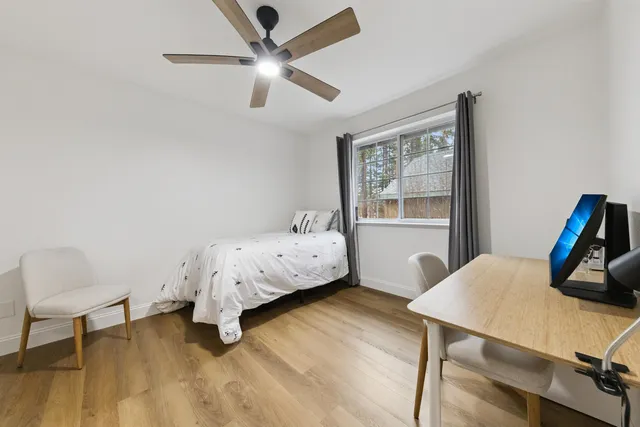 a bedroom with a bed a table and chair