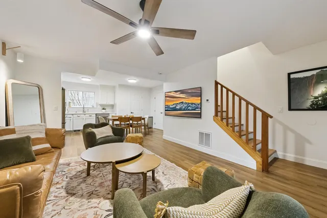 a living room with furniture kitchen and a dining table