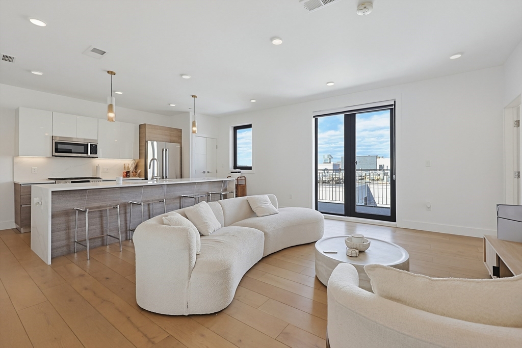 30 Penniman Road, Unit 605 Boston, MA 02134 - Photo 1 of 19 a living room with furniture and kitchen view