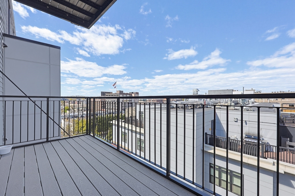 30 Penniman Road, Unit 605 Boston, MA 02134 - Photo 11 of 19 a balcony with wooden floor in city view