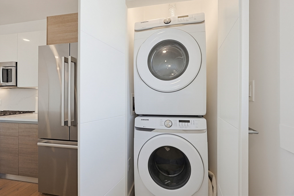 30 Penniman Road, Unit 605 Boston, MA 02134 - Photo 5 of 19 a view of a hallway with washer and dryer