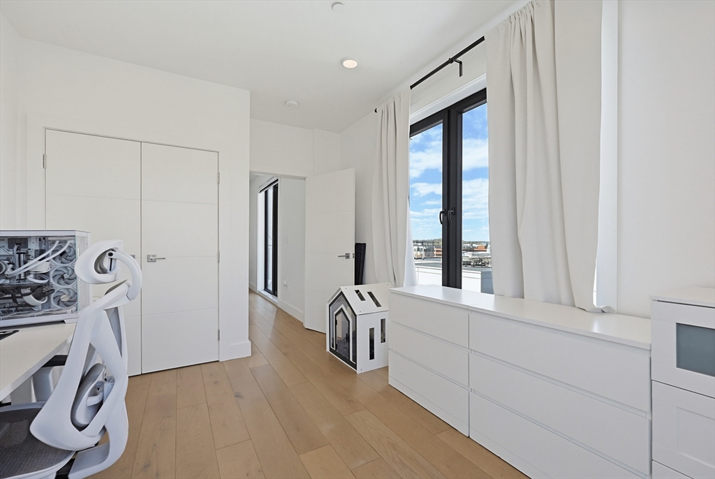 30 Penniman Road, Unit 605 Boston, MA 02134 - Photo 9 of 19 a view of a livingroom with furniture and windows