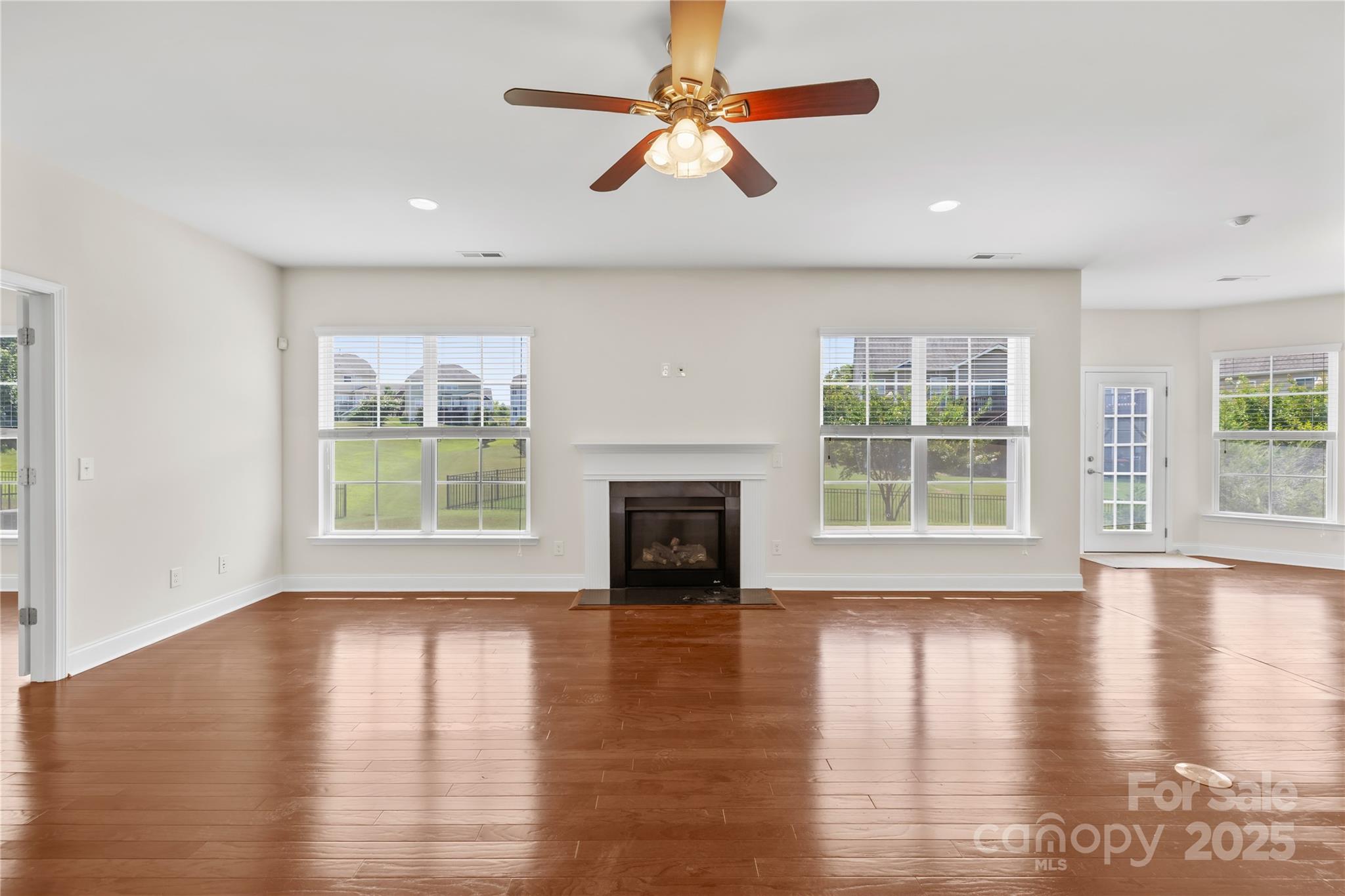 586 Brookhaven Drive Fort Mill, SC 29708 - Photo 12 of 47 a view of a livingroom with a fireplace a ceiling fan and front door