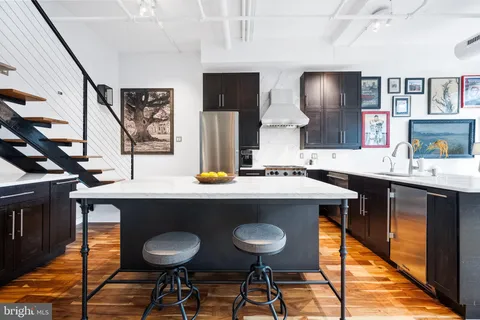 a room with a table chairs and entryway