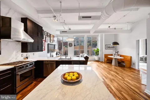 a kitchen with stainless steel appliances granite countertop a stove and a sink