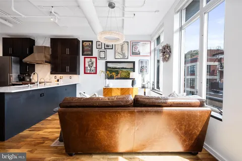 a living room with kitchen island granite countertop furniture and a fireplace
