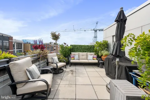 a view of a patio with table and chairs potted plants