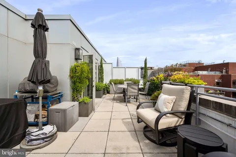 a living room with furniture a rug and white walls