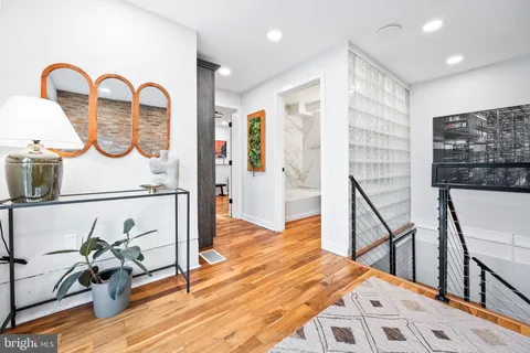 a view of entryway and hall with wooden floor