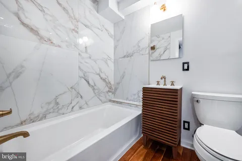a bathroom with a sink a toilet and bathtub