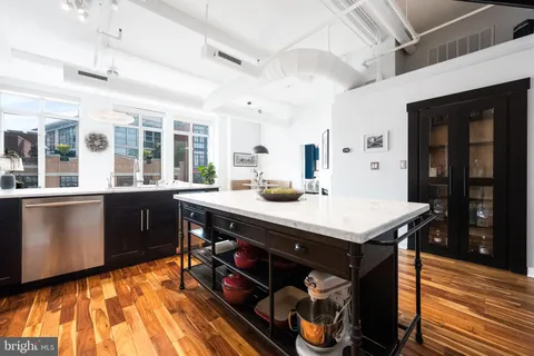 a kitchen with a sink appliances and cabinets