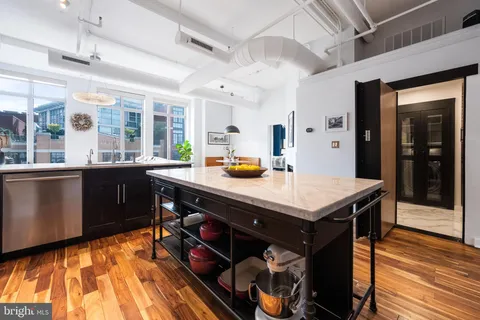 a kitchen with a stove a counter space and a sink