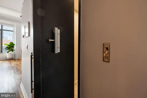 view of a hallway with wooden floor and a livingroom