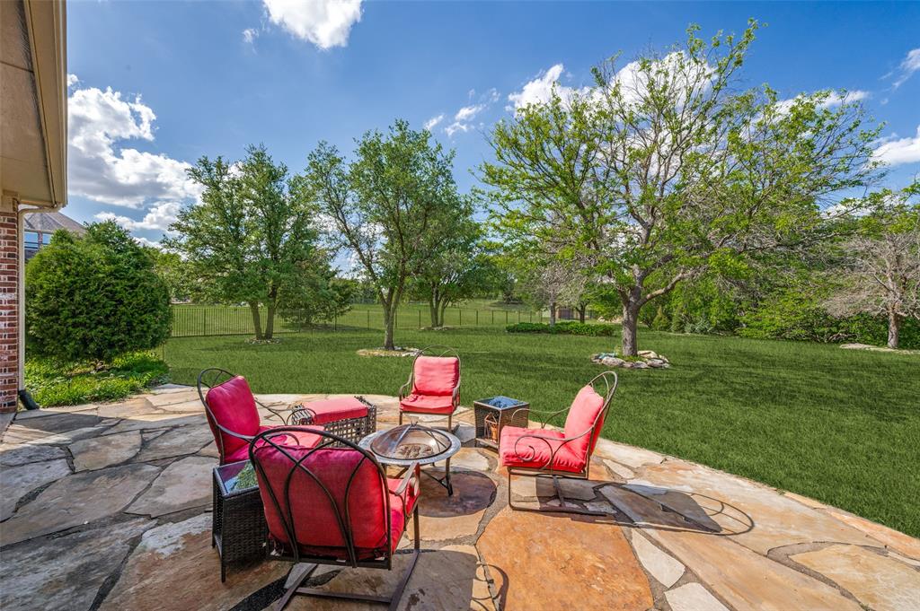2841 Winding Creek Road Prosper, TX 75078 - Photo 35 of 40 a view of a chairs and table in backyard of the house