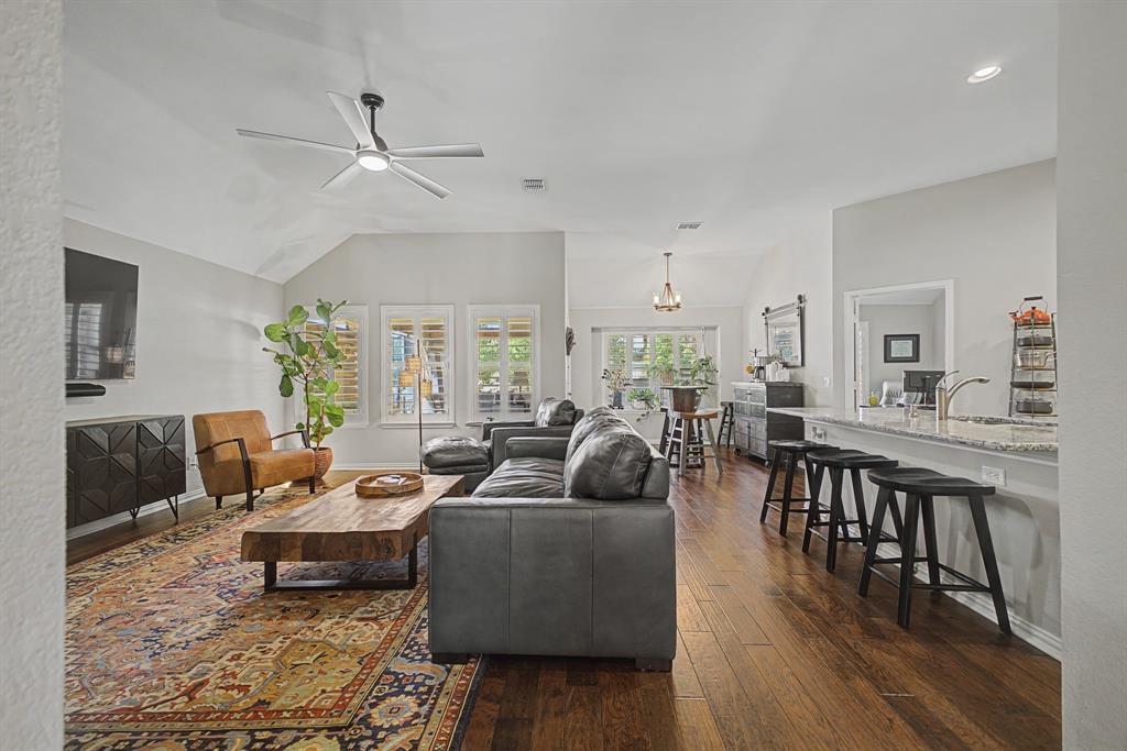 505 Scenic Ranch Circle Fairview, TX 75069 - Photo 13 of 32 a living room with furniture a wooden floor and a chandelier