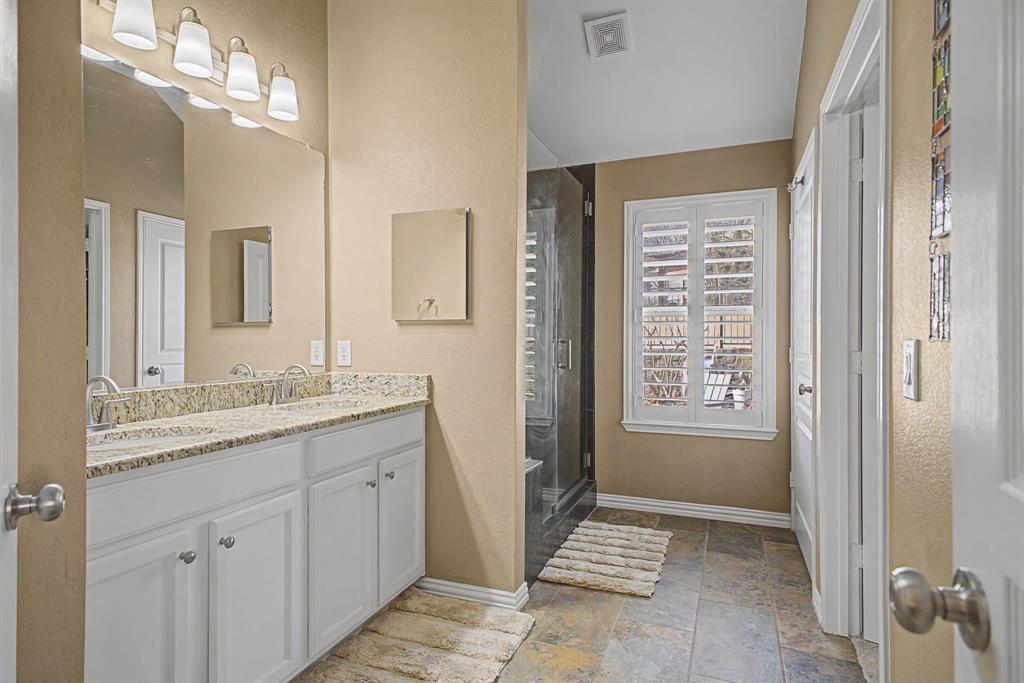 505 Scenic Ranch Circle Fairview, TX 75069 - Photo 17 of 32 a bathroom with a granite countertop sink a mirror and a shower