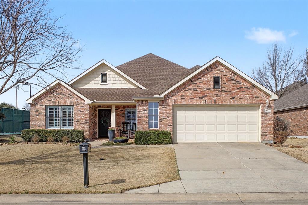 505 Scenic Ranch Circle Fairview, TX 75069 - Photo 2 of 32 a front view of a house with a garden and plants