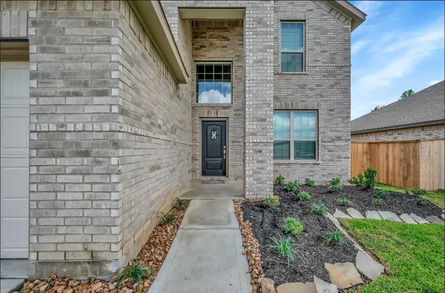 a front view of a house with a garden