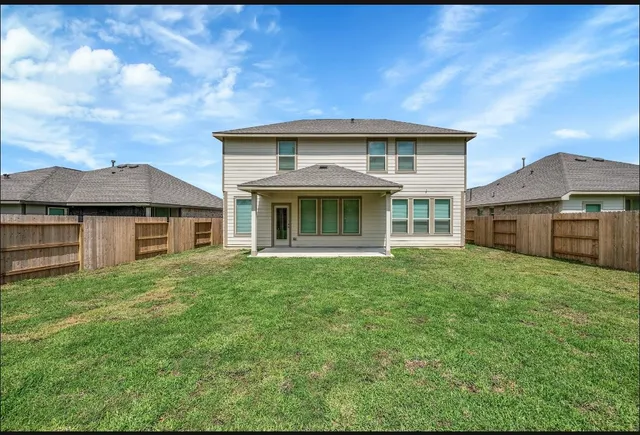 a view of a hallway with wooden floor and a living room