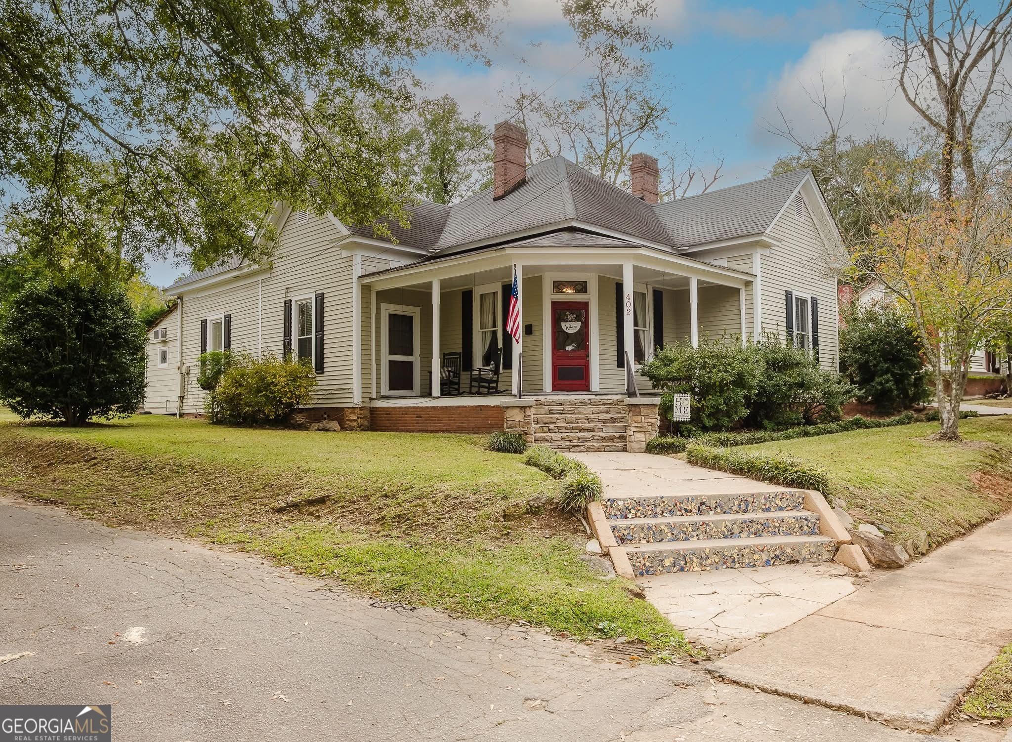 a front view of a house with garden