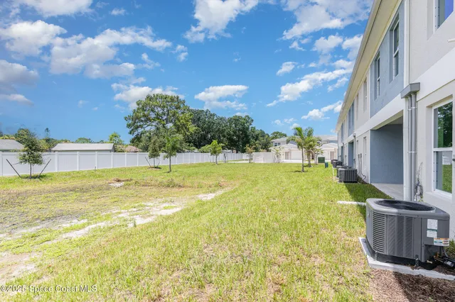 a view of an house with swimming pool and a yard