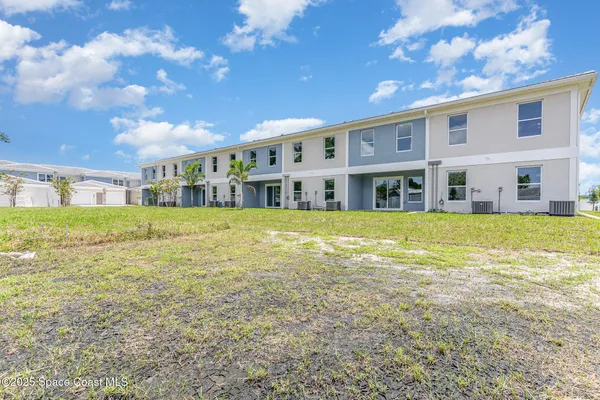 a view of an ocean with a big yard and large tree
