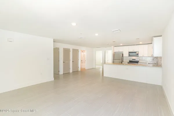 a view of kitchen and refrigerator