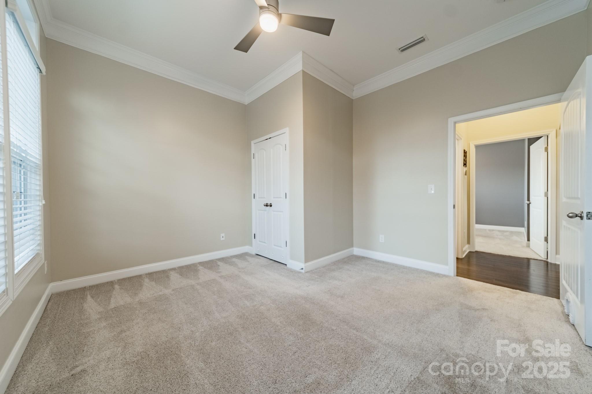 3419 Streamside Drive, Unit 463 Davidson, NC 28036 - Photo 21 of 43 an empty room with chandelier fan