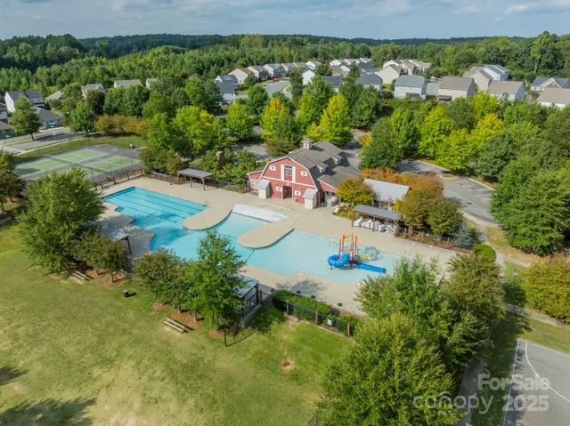 an aerial view of a house with a yard