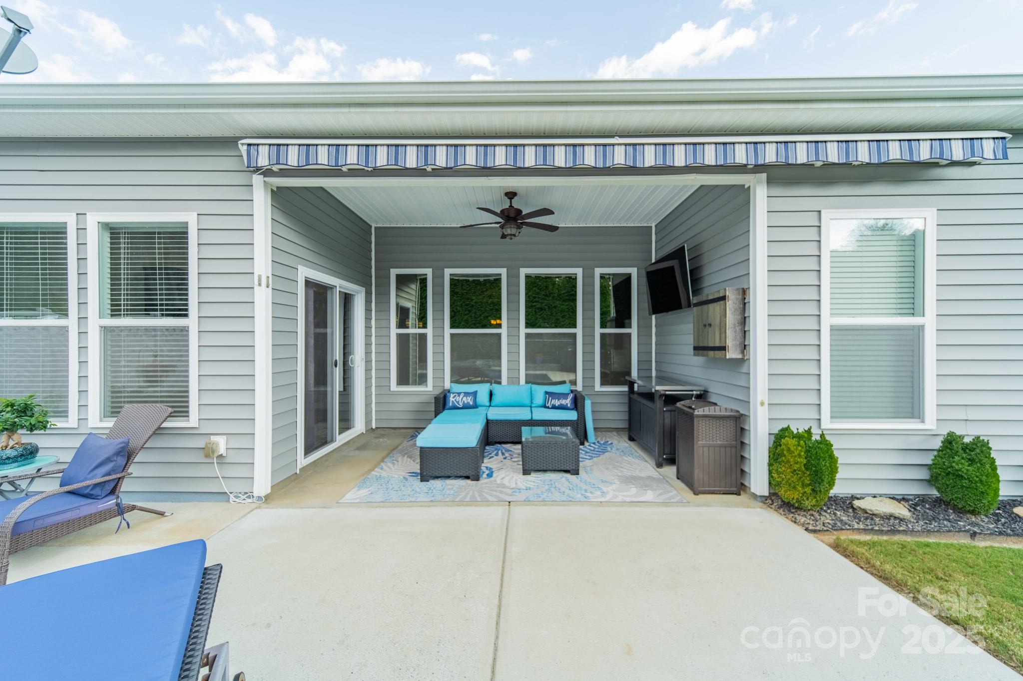 3419 Streamside Drive, Unit 463 Davidson, NC 28036 - Photo 38 of 43 a view of a patio with table and chairs potted plants and floor to ceiling window