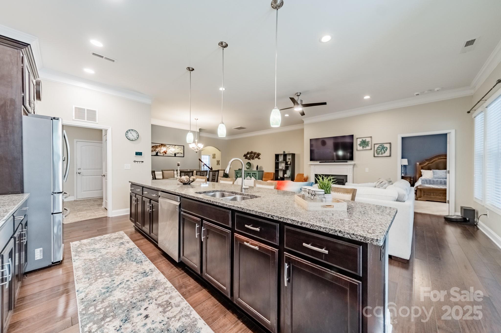 3419 Streamside Drive, Unit 463 Davidson, NC 28036 - Photo 6 of 43 a large kitchen with stainless steel appliances kitchen island granite countertop a large island in the center