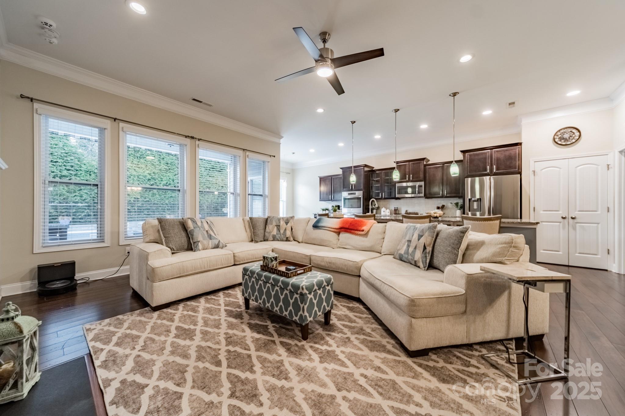 3419 Streamside Drive, Unit 463 Davidson, NC 28036 - Photo 10 of 43 a living room with furniture kitchen view and a large window